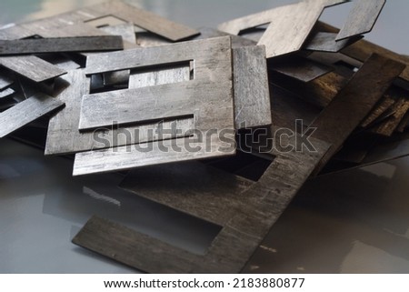 Defocused Pile of Ferromagnetic metal core for high energy efficient transformer.  Selective focus, shallow depth of field. Royalty-Free Stock Photo #2183880877