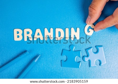 Branding. Text from white wooden letters on a blue background.