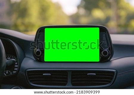 Close up display with green screen on car panel, car driving with navigation concept, blank screen dashboard.