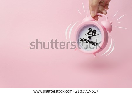 September 20th. Day 20 of month, Calendar date. The morning alarm clock jumping up from the bell with calendar date on a pink background.  Autumn month, day of the year concept Royalty-Free Stock Photo #2183919617