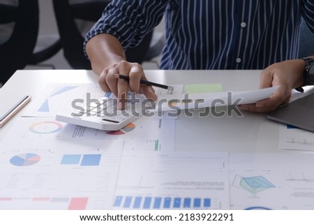 Asia stock trader agent or Sale tax loan broker advice brief and point hand to graph report talk to client at office desk show budget chart data or legal result on claim form. Trust will in work plan. Royalty-Free Stock Photo #2183922291