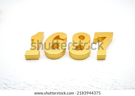     Number 1687 is made of gold painted teak, 1 cm thick, laid on a white painted aerated brick floor, visualized in 3D.                                