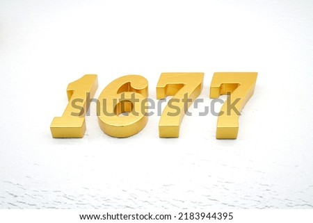    Number 1677 is made of gold painted teak, 1 cm thick, laid on a white painted aerated brick floor, visualized in 3D.                                