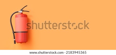 Fire extinguisher on orange background with space for text