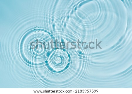 Blue water texture, blue mint water surface with rings and ripples. Spa concept background. Flat lay, copy space. Royalty-Free Stock Photo #2183957599