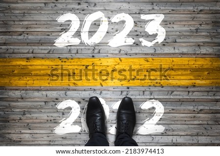 Welcome 2023 - Goodbye 2022 - New Year Start Concept Royalty-Free Stock Photo #2183974413