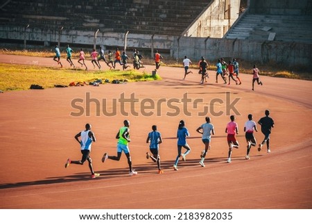 Kenyan runners training on the athletics track in the morning in Eldoret. Illustration photo for marathon, running and athletics. Track and Field Training in Kenya