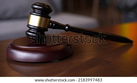 Lawyer or judge's hammer in the court. Auction's hammer is on woo table. Law subject. Auction hammer on table.