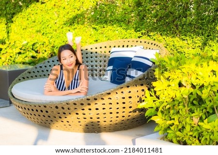 Portrait beautiful young asian woman relax smile leisure on vacation around swimming pool in resort hotel