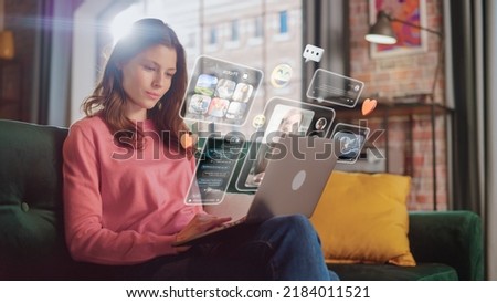 Young Beuatiful Women Using Laptop Computer To Check Social Media, Listen To Music and Read Emails. Creative Person Catching Up With Friends Online. 3D Visualization of Online Platforms Concept. Royalty-Free Stock Photo #2184011521