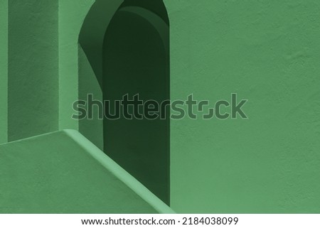 green painted wall fragments  with smooth surfaces with geometric shapes details. Abstract architecture forms for background. empty straight and curved lines. concept of minimalism, balance, modern