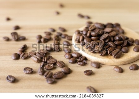 close up of coffee beans roasted on wooden table 