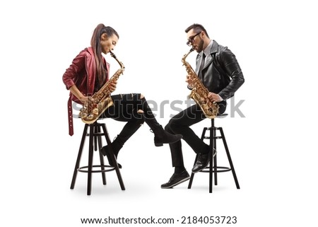 Modern young sax players sitting on chairs and performing isolated on white background
