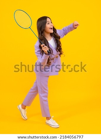 Teen girl badminton player with badminton racket isolated on yellow background. Royalty-Free Stock Photo #2184056797
