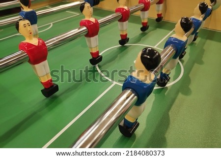Table football, commonly called fuzboll or zaa (as in the German Fußball "football") and sometimes table soccer, is a table-top game that is loosely based on association football. Royalty-Free Stock Photo #2184080373