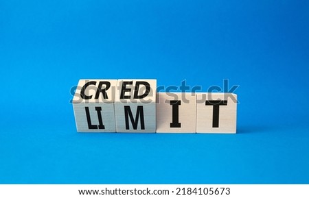 Credit limit symbol. Turned wooden cubes with words credit and limit. Beautiful blue background. Business and Credit limit concept. Copy space Royalty-Free Stock Photo #2184105673