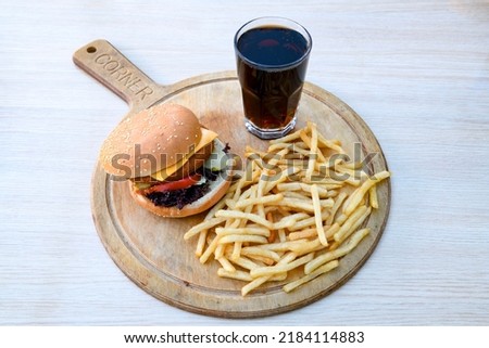 Big tasty burger with beef cutlet on a plate