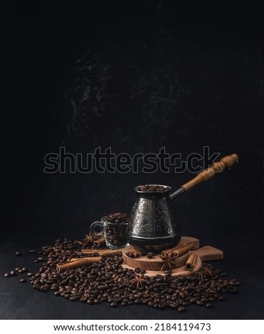 Coffee beans background. Roasted Coffee concept with differents types of coffee, beans and cinnamon sticks on black background. Coffee concept. Mock up