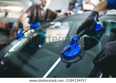 Replacement of car glass in a car service. Royalty-Free Stock Photo #2184134957
