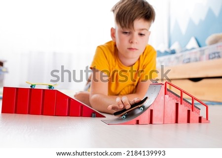 Boy playing with a toy skateboard