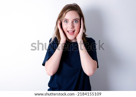 young caucasian woman wearing black T-shirt over white background Pleasant looking cheerful, Happy reaction