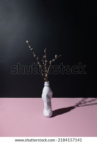 Vase made of used plastic bottle. Ecology,recycling and pollution problem concept. Minimal composition. black and pale pink background.