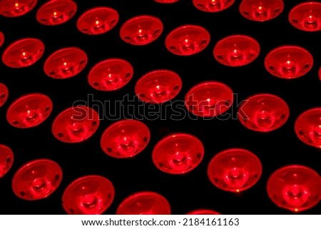 Full frame of red lights concept for recovery and rehabilitation therapy, skincare healing and rejuvenation procedure Royalty-Free Stock Photo #2184161163