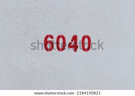 Red Number 6040 on the white wall. Spray paint.
