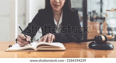 Business woman working or reading lawbook in office workplace for consultant lawyer concept.