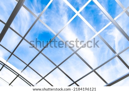 Blue sky over the metal grid frame.
