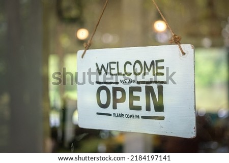 "Welcome, open" signboard of the cafe and food restaurant which is display at the entry. Sign and symbol object photo for business using.