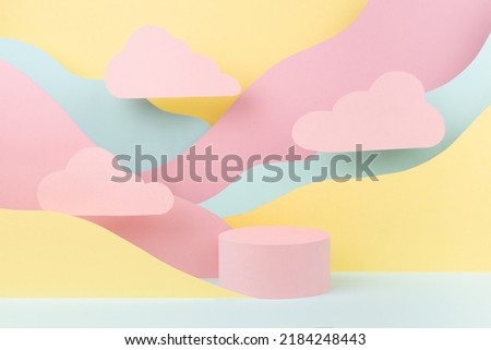 Tender fashion style paper abstract stage mockup - pink circle podium, pastel mountain landscape - yellow, mint color slopes, clouds. Template for advertising, presentation cosmetic produce, showcase.