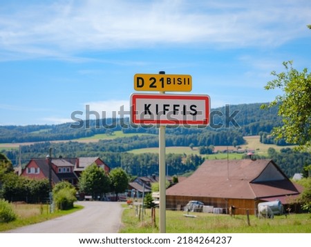 Road sign at entrance of French mountain village Kiffis on summer day.