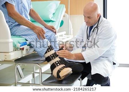 doctor helping to patient with prosthetic leg in the hospital Royalty-Free Stock Photo #2184265217