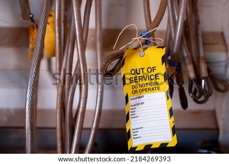 Safe workplaces practices yellow out of service warning tag sign placing on damaged faulty unsafe to use industrial fall arrest structural industrial hard link 25 KN rope access anchor point