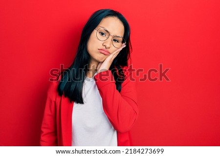 Beautiful hispanic woman with nose piercing wearing casual look and glasses thinking looking tired and bored with depression problems with crossed arms. 