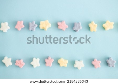 sweet color candy in the form of stars on blue background