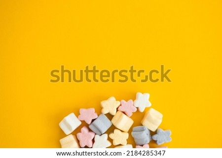 gummy candies on yellow background. Top view. Jelly sweets.