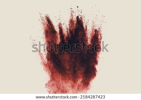 Red dust particles explosion on white background.Red sand splash.