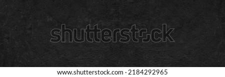 Black rough old concrete wall distressed texture. Dark grunge panoramic textured background