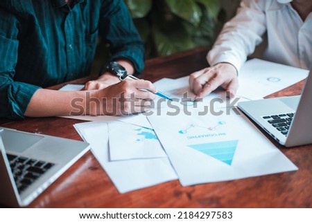 Hand businessman signing contract. Asia businessman check the correctness of work at the office with a beautiful pen. Hands working with documents at desk and signing contract.Deal concept.