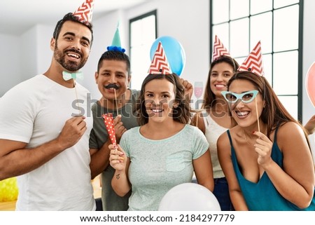 Group of young hispanic friends having birthday party smiling happy and looking to the camera at home.