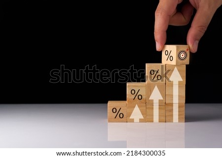 wooden cube planning to invest in stock market. wooden cube success goals icon on virtual screen, stock graph is rising, economy is recovering, stock trading, bussiness start up, business success.