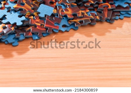 Colorful Peaces of a Mixed Jigsaw Puzzle Lie on the Wooden Table - Strategy and Solving Problem Concept