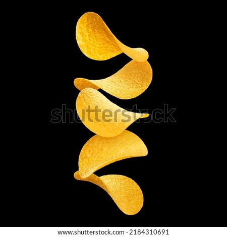 Delicious potato chips, isolated on black background Royalty-Free Stock Photo #2184310691
