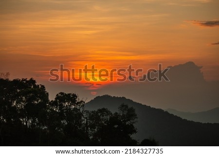 the sunset behind the mountains