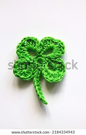 colorful flowers and clover leaf made of yarn on a white background