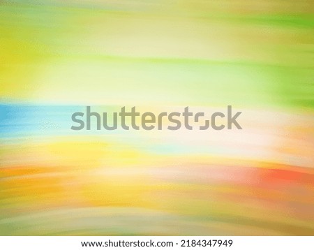 Blurry landscape with green hills and sunset. Glowing nature backdrop with pink orange sunburst on sky and grassy field.