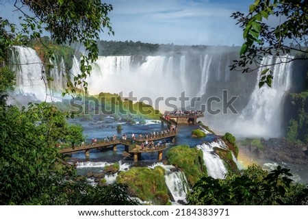 Tourists exploring Iguazu Falls on the border of Brazil and Argentina. Royalty-Free Stock Photo #2184383971