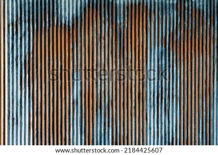 Artistic of old and rusty zinc sheet wall. Vintage style metal sheet roof texture. Pattern of old metal sheet. Rusting metal or siding. Corrosion of galvanized. Background and texture in retro concept Royalty-Free Stock Photo #2184425607